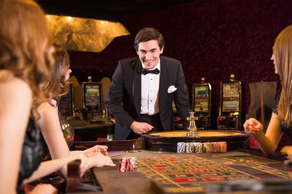 BA98 Slots — Thousands of exciting themes and jackpots A stylish woman beside vibrant slot machines displaying glowing sevens, showcasing the variety of top slots at BA98.