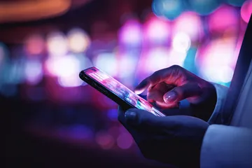 BA98 Slots — Thousands of thrilling machines await A woman smiling by bright slot machines showing lucky symbols, showcasing the exciting slot offerings at BA98.